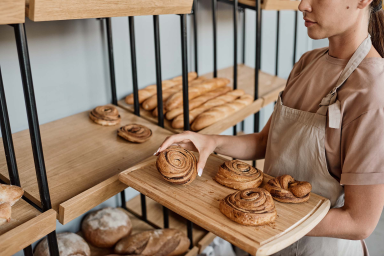 woman-with-tray-in-bakery-XDW7NK5.webp